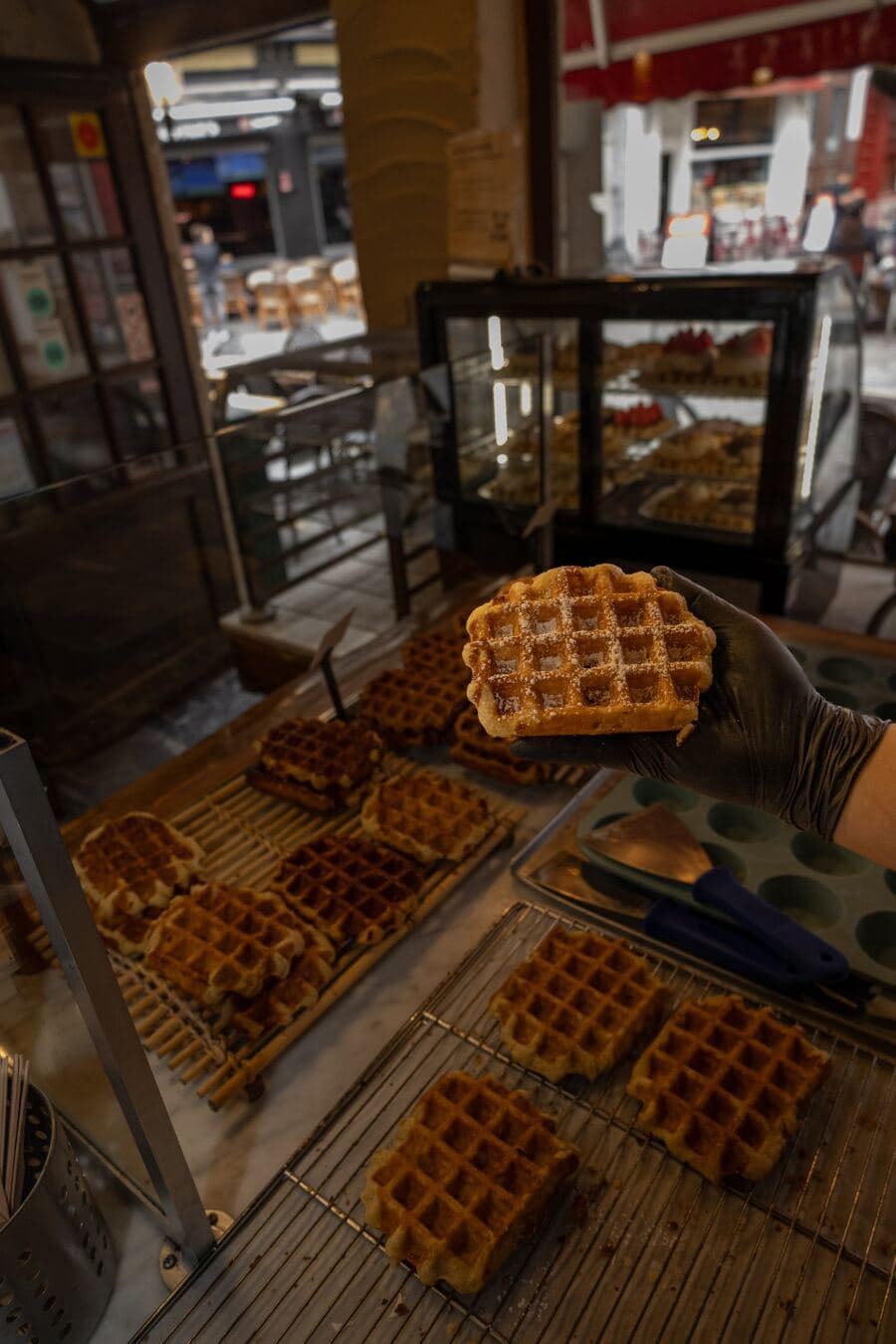 A classic Liège waffle with powdered sugar, fresh from Le Roi de la Gaufre